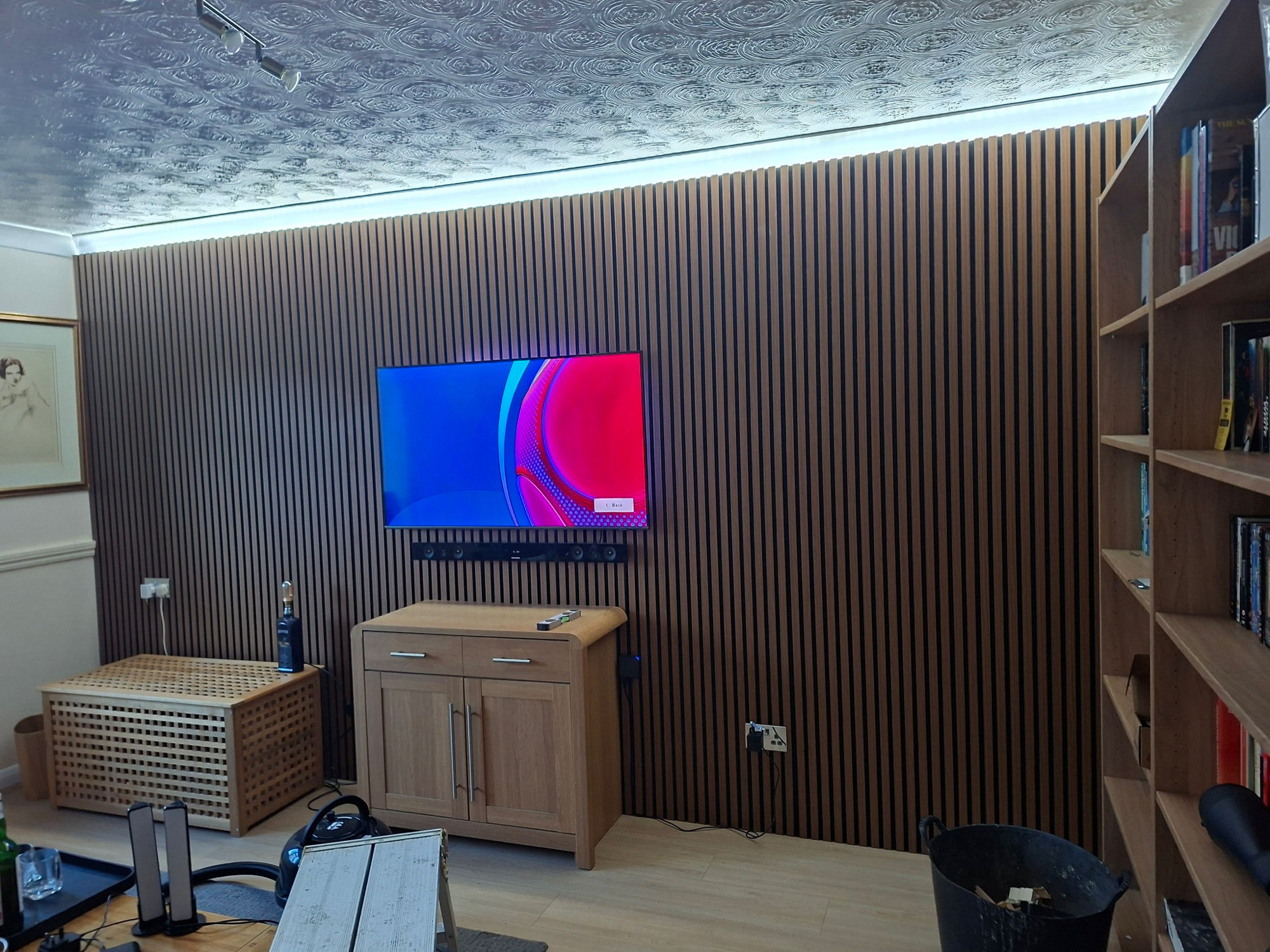 Oak slatted feature wall with wall-mounted TV and integrated lighting, fitted in Sleaford